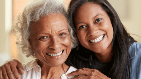 Someone posing and smiling with their elderly relative
