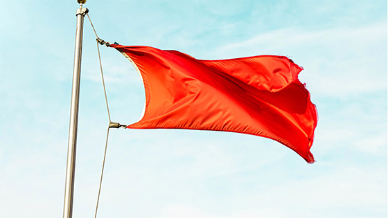 a red flag waving in the air, image used for a blog post about financial red flags for not-for-profit boards