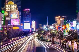 Las Vegas boulevard lit up at night with buildings and traffic lights