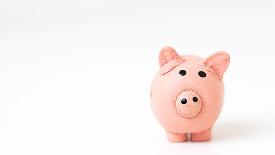 a pink ceramic piggy bank; image used for a blog post about four ways the new tax law change affects a retirement plan
