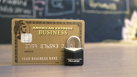 a gold American Express Business credit card sitting behind a master lock; used for a blog about avoiding credit card misuse for not-for-profit organizations