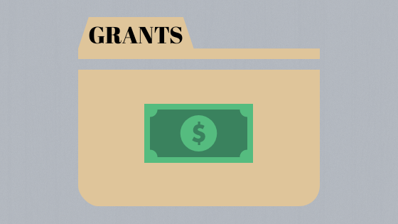 graphic of a manila folder with the word "grants" and a dollar bill; image used for blog post about not-for-profits accepting grants