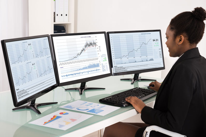 woman looking at graphs in a desktop