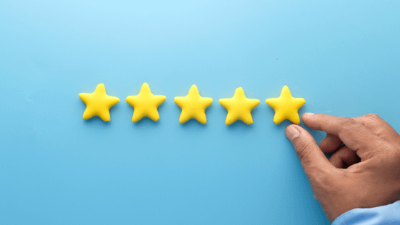 Someone putting a fifth star in a row of four stars; image used for blog post about not-for-profit client feedback