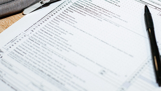 a pen sitting on top of a tax form; image used for blog post about Employee Retention Tax Credit