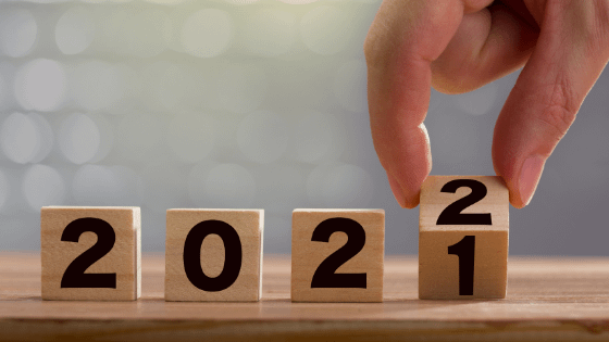 a person placing number blocks and changing from 2021 to 2022; image used for blog post about revised amounts for 2022 taxes