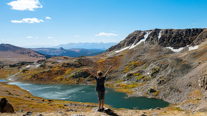 How To Become A Full-Time RV Family - Fulltime Families Young boy standing on a hillside overlooking a lake below | fulltime families