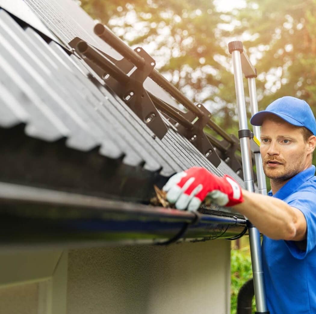 man cleaning gutters professional from broken arrow cleaning house gutter