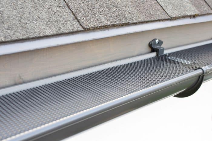 Gutter guard installation helping prevent debris buildup, standing water, and pest-friendly conditions