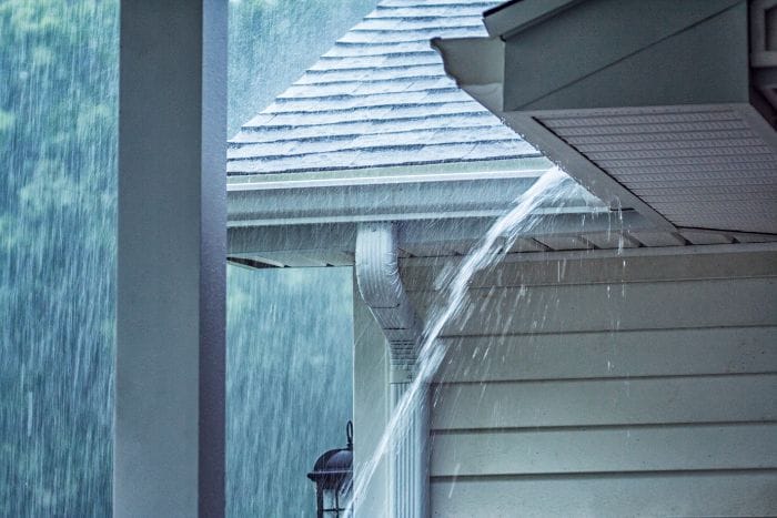 Gutter overflow showing a drainage problem on an East Texas home