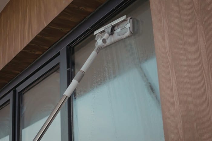 Long reach window cleaning tool used for exterior glass