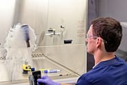 EAB Technician using smoke test to validate airflow patterns in a controlled cleanroom