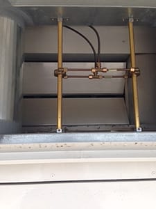 Portions of airflow sensor ports installed above the air path into the rooftop air handling unit