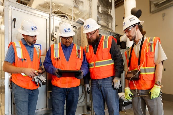EAB commissioning team reviewing mechanical system data to ensure optimal building performance and compliance