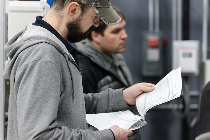 Project team member reviewing pre-TAB checklist before smoke control testing