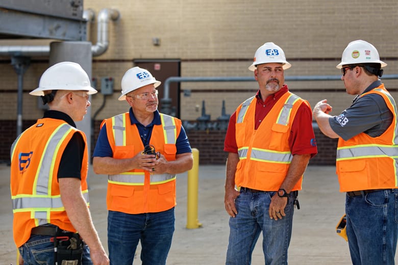 EAB commissioning engineers having an outdoor meeting at a project site