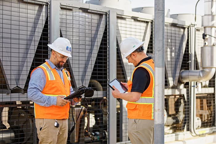 EAB commissioning engineers inspecting rooftop HVAC equipment