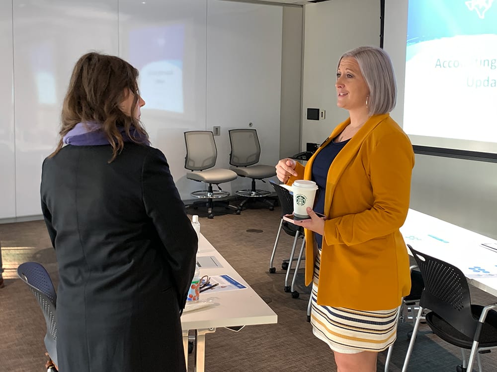 A photo of two people in conversation at PKF Texas seminar, "2022 Accounting and Tax Updates and Changes for Not-for-Profits"