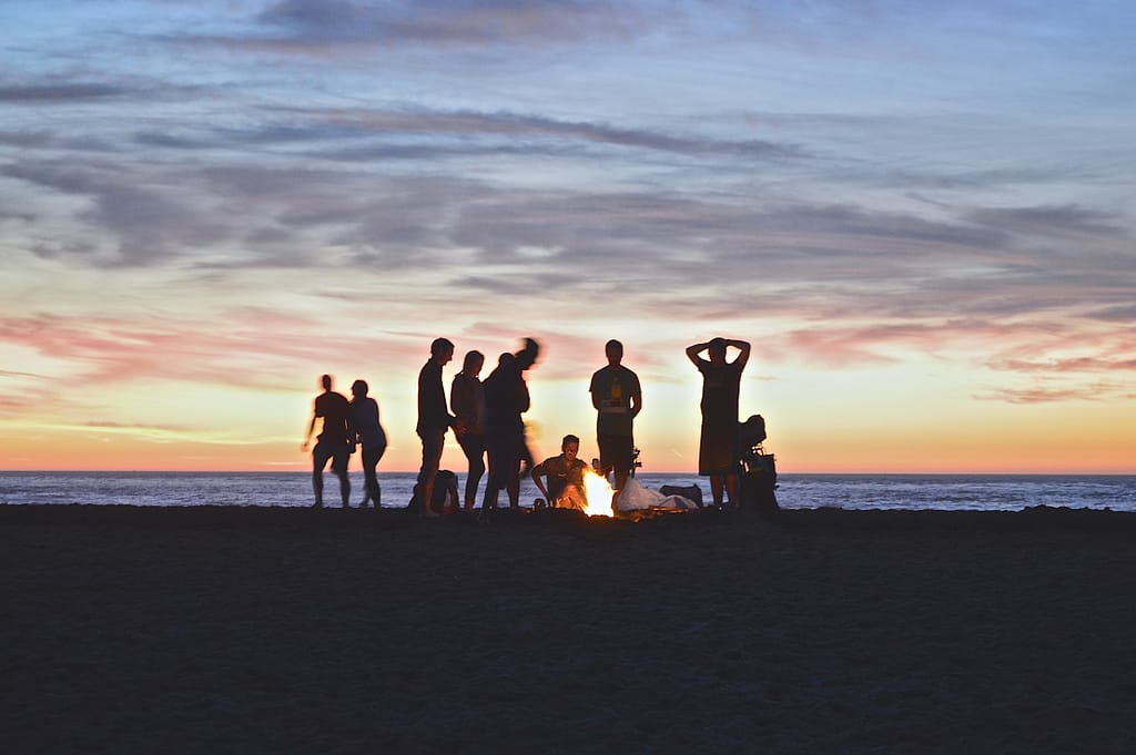 Traveling community around a campfire on the beach