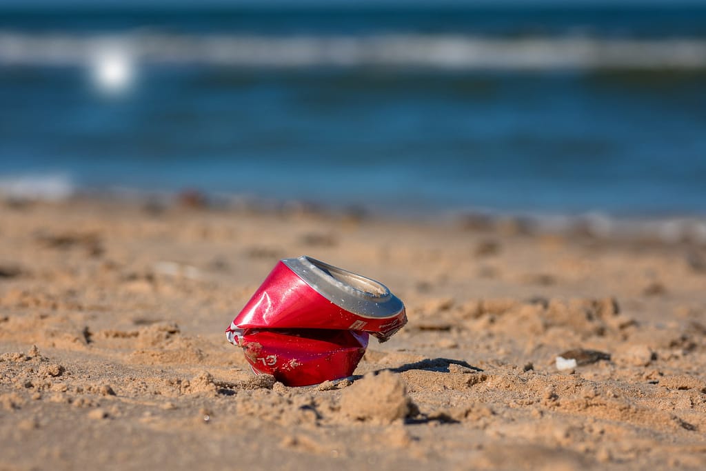 Empty can sitting on the beach