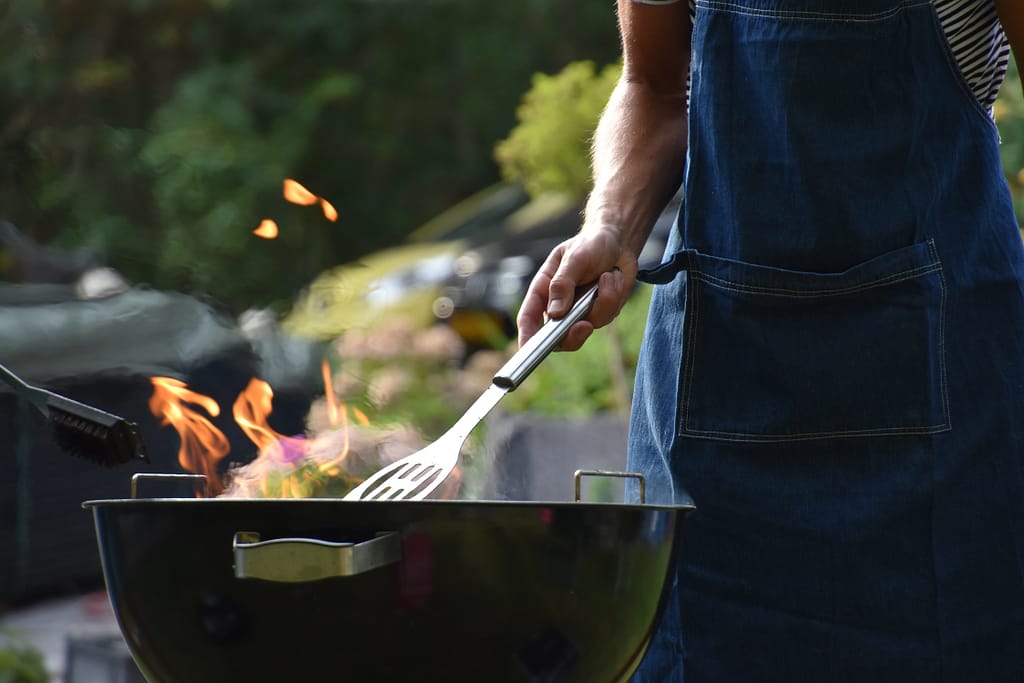 RV food ideas: man cooking on a grill