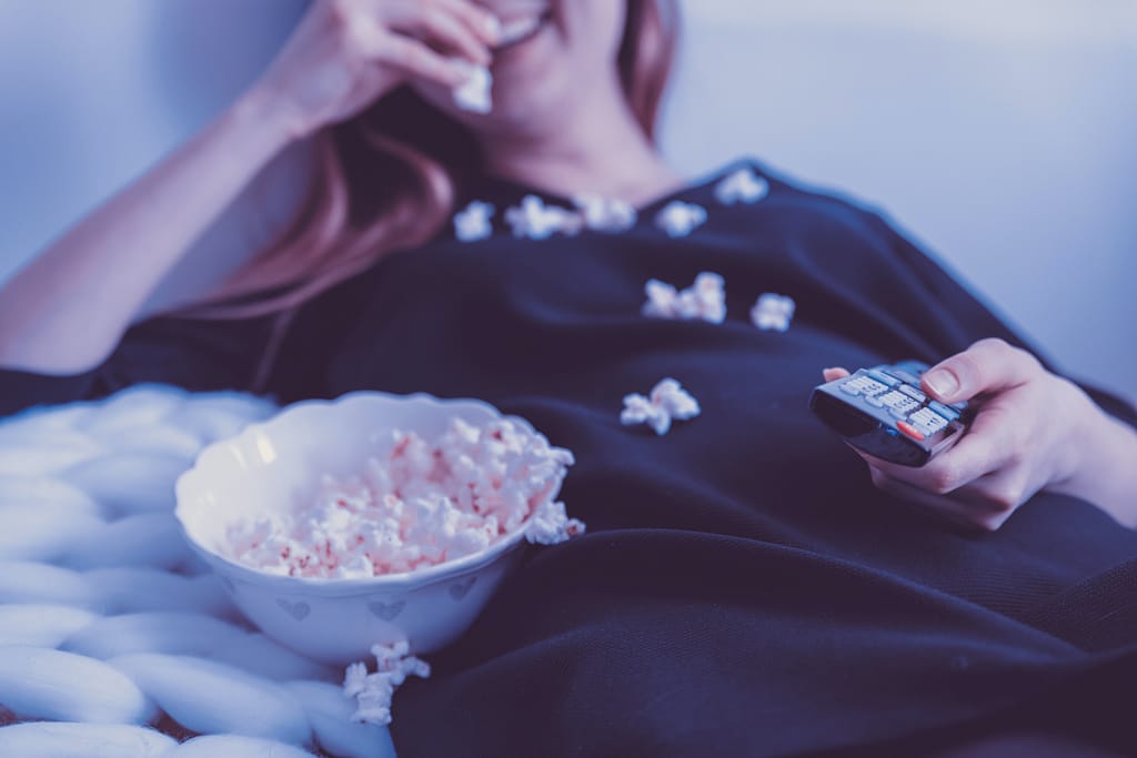 Woman watching an RV movie with popcorn