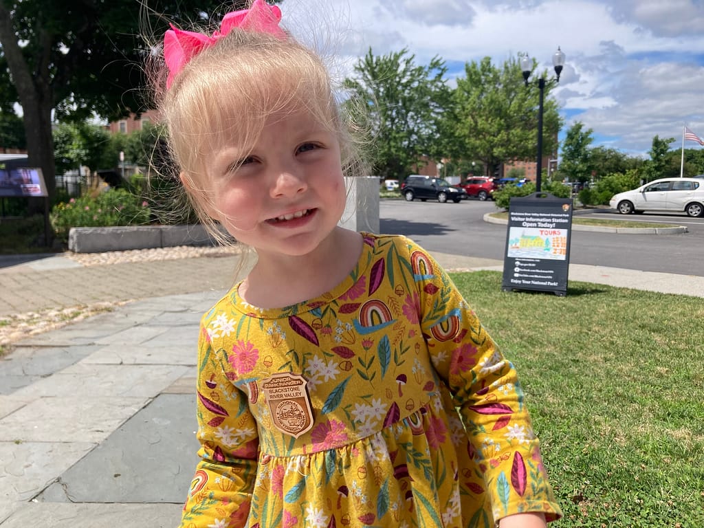 Girl with Junior Ranger badge