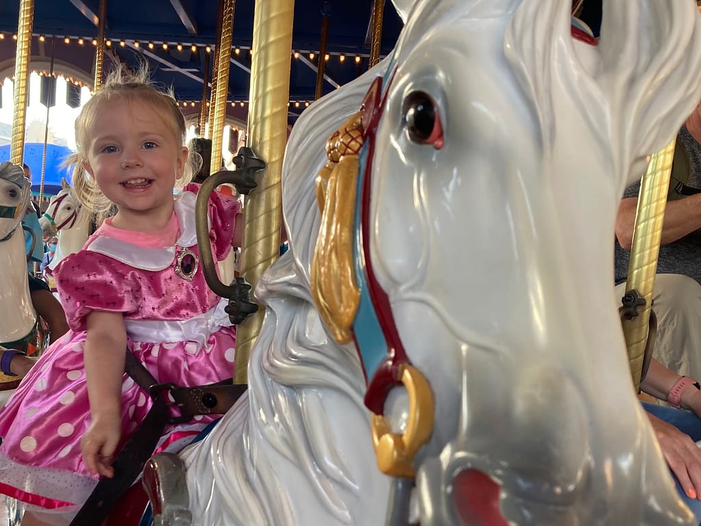 Girl on carousel in Disney World