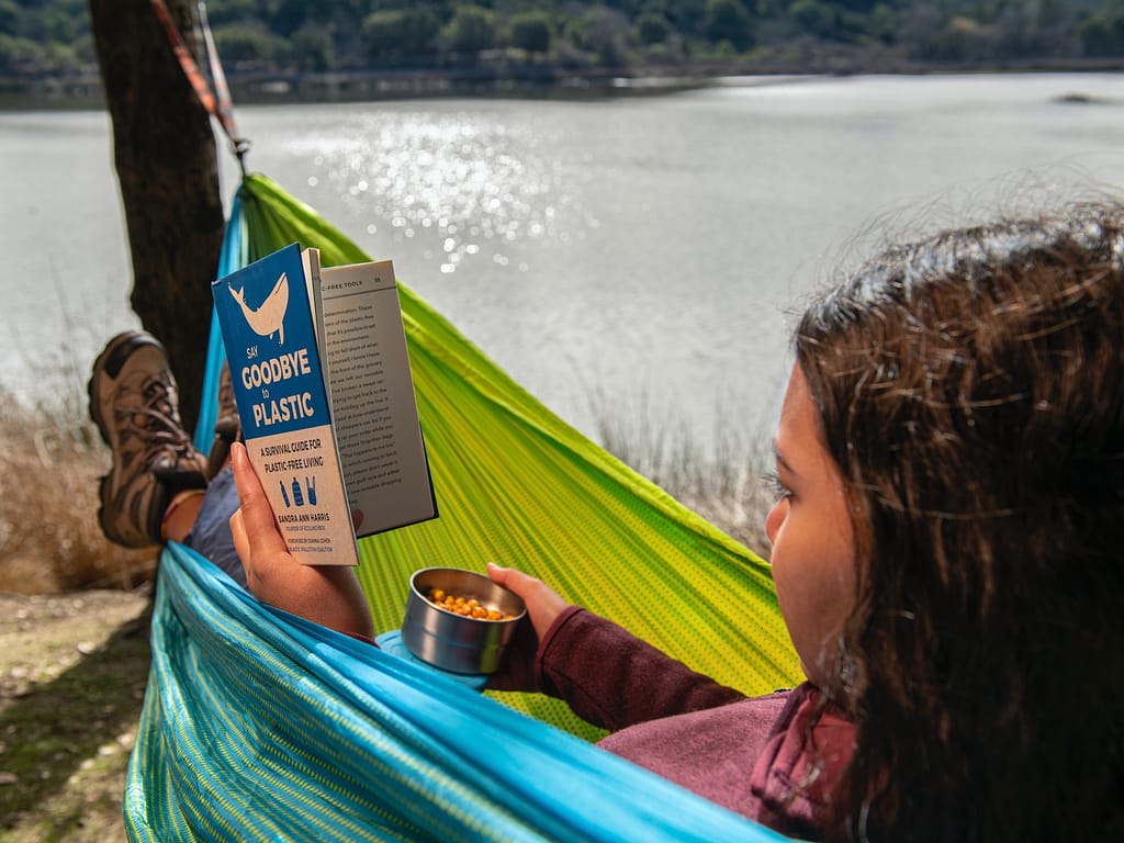 Girl reading in hammock: roadschool laws consider this schooling