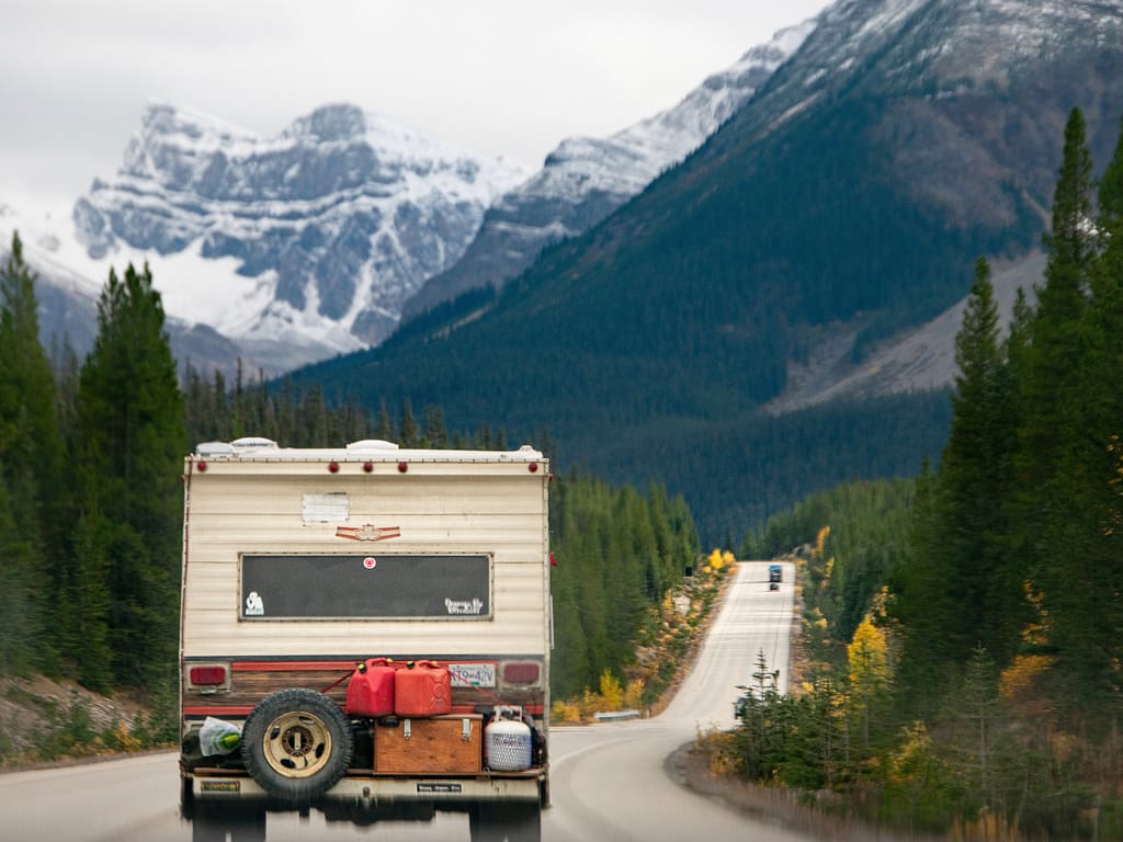 RV driving up a mountain to go camping in the mountains