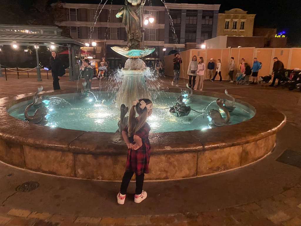 Girl in front of fountain in Disney World
