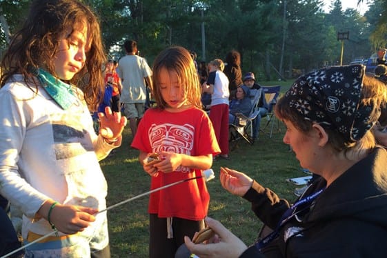 rv kids gather around mom for marshmallows and s'mores