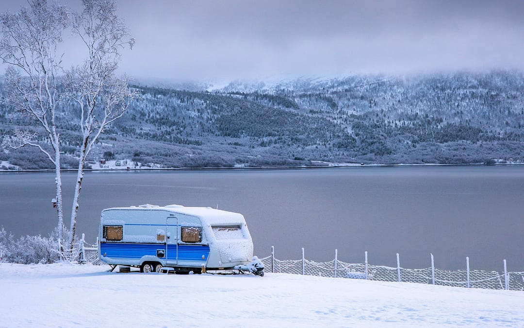 RV parked in snowy field. How much snow can an rv roof handle?