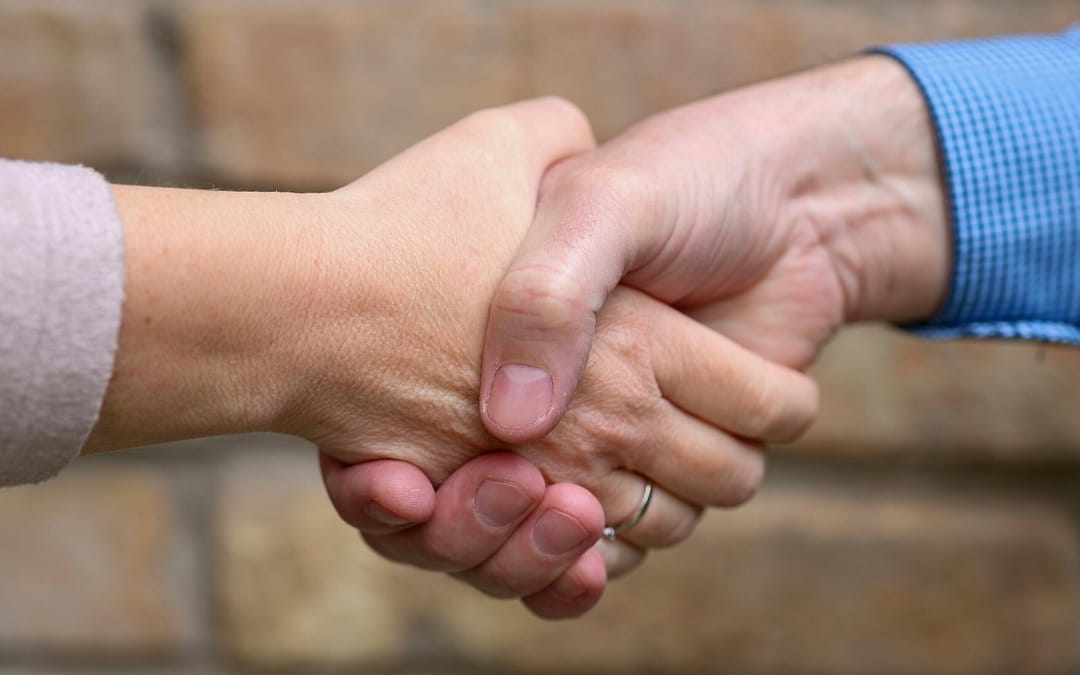 People shaking hands after buying an RV