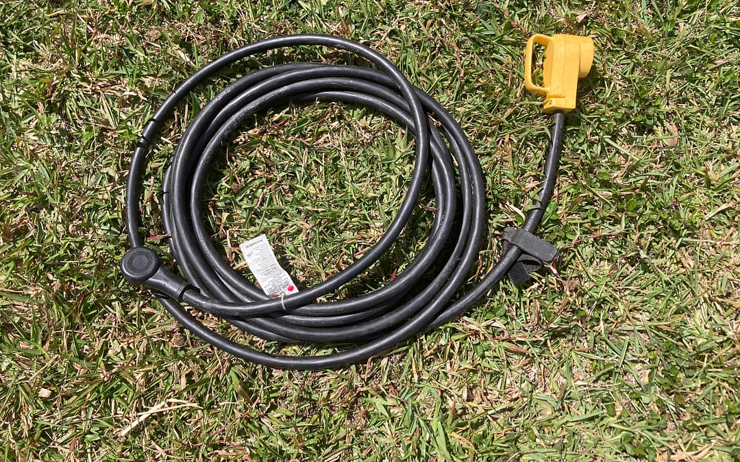 RV extension cords coil nicely. This one is coiled in the grass.