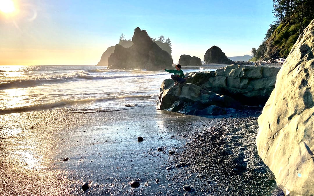 Boy playing on beach at Olympic National Park, a must visit spot while camping in Washington