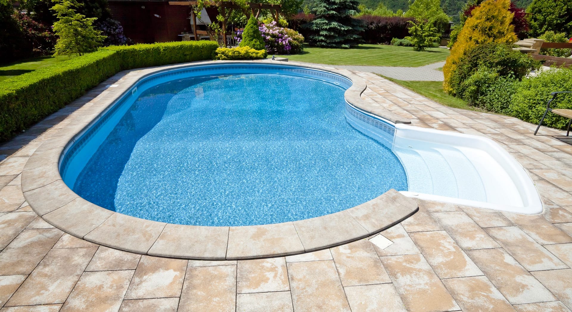 an attractive and modern swimming pool with a striking decking design