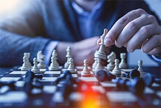 man playing chess in a suit; image used for blog post about upcoming Houston Events