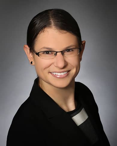 professional headshot of Danielle Supkis Cheek, a brunette woman wearing glasses with her hair pulled back smiling at the camera