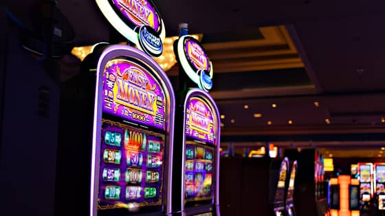 A photo of two slot machines to show the tax implications of winning the lottery or by gambling.