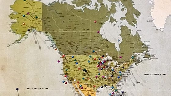 a map of the United States and Canada with colored pins to signify the possibility of nonprofit organizations needing registration in various states