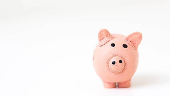 a pink ceramic piggy bank; image used for a blog post about four ways the new tax law change affects a retirement plan
