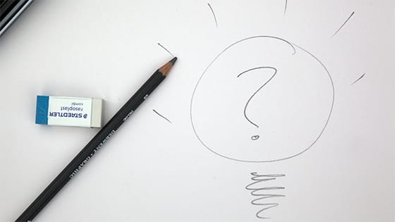 a pencil and eraser point to a drawing of a lightbulb with a question mark in the middle; image used for blog post about assessing a not-for-profit