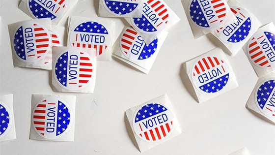 various "I voted" stickers scattered on a table, image used for blog post about not-for-profits carefully navigating upcoming election