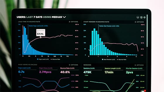 a computer screen shows data with bar graphs, metric numbers and more; image used for blog post about financial dashboards helping not-for-profit success