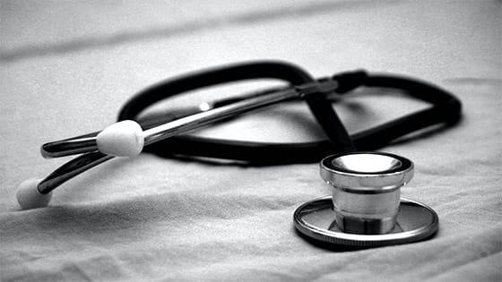 a stethoscope lying on a table; image used for blog post about writing off Medicare premiums