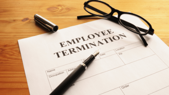 A pen and eye glasses sitting on top of a document reading, "Employee Termination," image used for blog post about tax aspects of employee termination