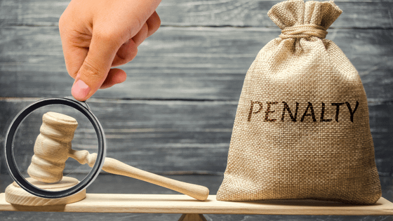 An image of a gavel and bag labelled "penalty" sitting on a wooden plank; for blog post about retirement plan early withdrawal penalties