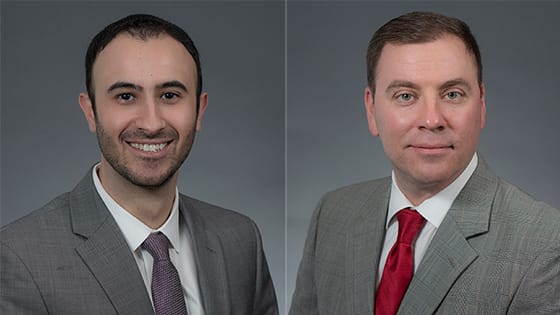 a photo of two gentlemen in grey suits; Sam Razmandi and Martin Euson of PKF Texas