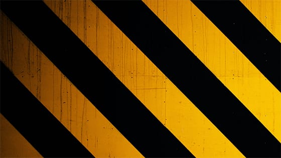 black and yellow diagonal stripes of a warning sign; image used for blog post about financial warning signs for not-for-profits